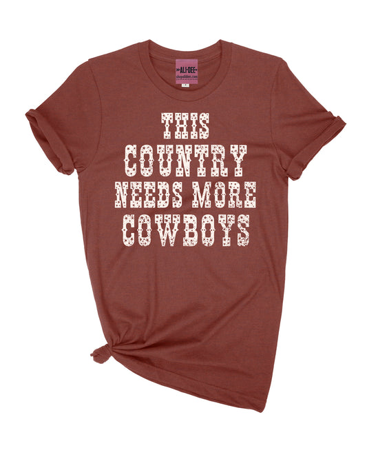 This Country Needs More Cowboys Graphic Tee - Heather Clay
